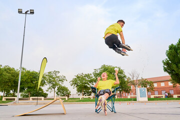 Rollerblader performing high jump over laughing woman in outdoor park