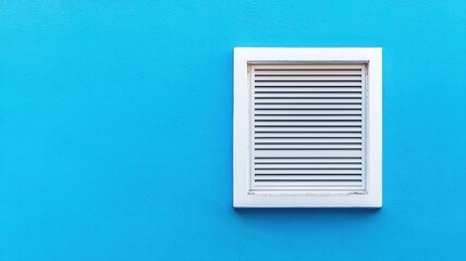 White Louvered Vent on Vibrant Blue Wall Exterior Architectural Detail