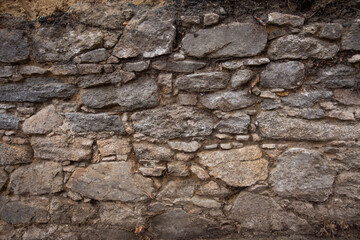 old stone wall made of granite stone