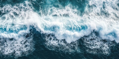 Fototapeta premium Beautiful aerial view of ocean waves crashing against the shore, creating a stunning scene.