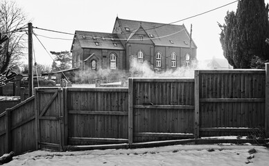 Steaming fence with old church in background
