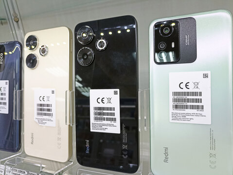 Display of various modern redmi smartphones with ce marking labels in store