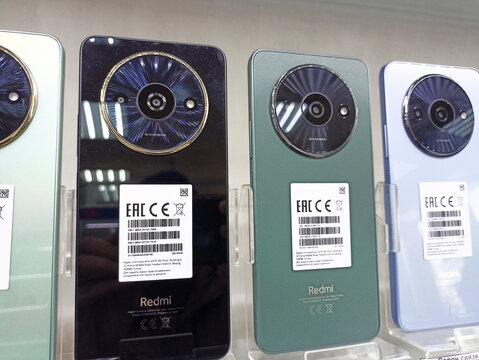 Display of redmi smartphones with circular camera design in various colors