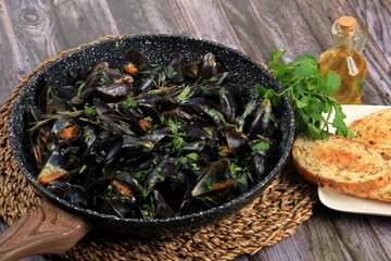 Fresh mussels on a pan with spices and white wine. Mussel cooking recipes