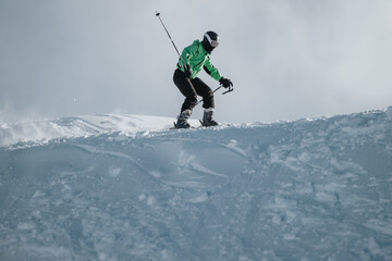 Energetic skier gliding down a snowy peak under a bright sky, showcasing adventurous skills on the slopes. The serene landscape contrasts the action, depicting winter sports excitement and
