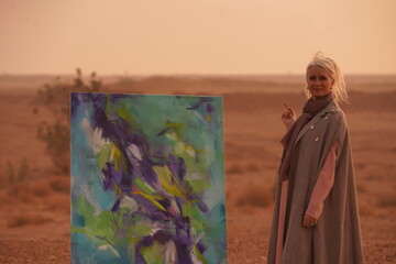 Artist Presenting Abstract Painting in Desert at Sunset