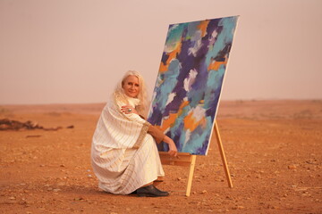 Female Artist Painting Abstract Art in Desert at Sunset