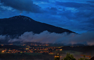 Night view of Patscherkofel mountain and valley with town street lights in Innsbruck, Austria