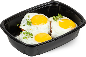 Meat cutlet with egg in a black plastic lunchbox photo on a white background