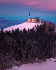 A church on top of the hill in the winter sunset