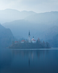 Island of Bled with church on it in the fog, Slovenia