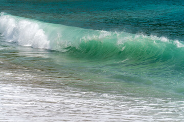 Green clear curly sea wave is crashing. Windy day on the Mediterranean Sea. 