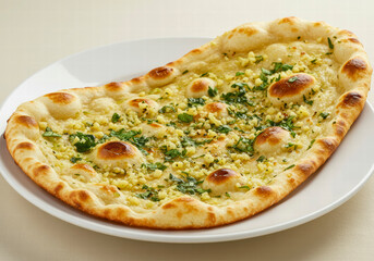 Fresh Indian Naan Bread Garnished with Herbs and Garlic Seasoning, Served on a Plate for a Flavorful Delight