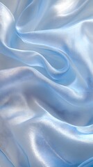Obraz premium Serene Blue Silk Drape: Luxurious, light blue silk fabric gracefully drapes and folds, creating a dreamy, ethereal texture.