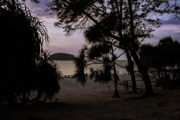 Sunset Kata Karon Phuket Thailand nice orange and purple skies and turquoise beach waters with Palms tree sunset sunrise