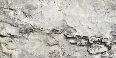 Textured background of an old gray rock wall, close-up view with visible joints and worn edges. The natural variations in stone shades and patterns evoke a timeless, earthy aesthetic, ideal for rustic