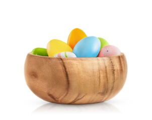 Bamboo bowl full of Easter colorful eggs isolated on a white background