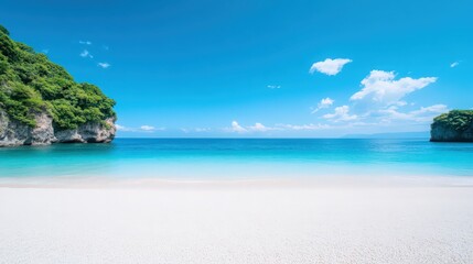 Obraz premium A beautiful beach with a clear blue ocean and a mountain in the background