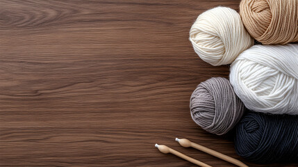 Yarn balls and knitting needles on wood. Crafting hobby background