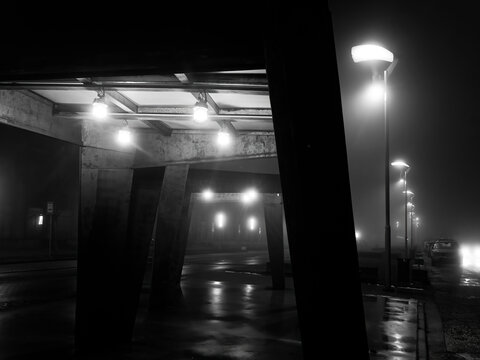 Fototapeta Night city in the fog. Black and white photo Selective focus.