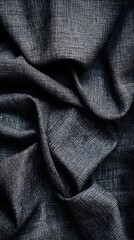 Obraz premium Textured Charcoal Fabric: A close-up shot reveals the intricate texture of a charcoal-colored fabric, the soft folds creating a dynamic interplay of light and shadow.