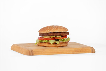 Hamburger on a wooden board on a white background, isolate