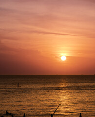 Sunset Kata Karon Phuket Thailand nice orange and purple skies and turquoise beach waters with Palms tree sunset sunrise