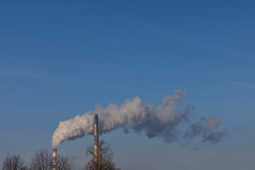 Smoke from a factory chimney over the city in winter. Wroclaw, Poland