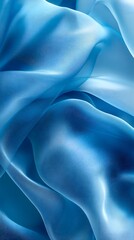Obraz premium Azure Silk Drape: Luxurious folds of light blue silk create a captivating abstract pattern, showcasing the fabric's sheen and subtle texture. The image evokes feelings of serenity and elegance.