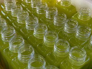 Contain homemade juice in plastic bottles, Healthy guava fruit juice ready to drink in bottle packaging ready for the cap locked, Processing homemade cold drinks, Beverage background.