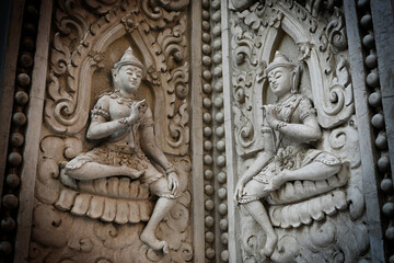 Ancient Statue Craving on the wall at the temple in Thailand
