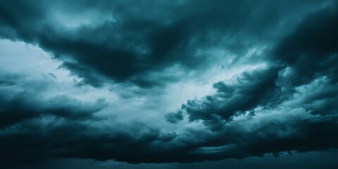 Obraz premium Dramatic teal cumulonimbus clouds looming menacingly, signaling imminent thunderstorm with ominous, brooding sky landscape
