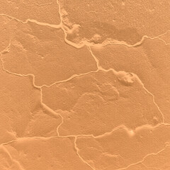 Square golden brass. Stone surface. Abstract golden background. Dry ground effect. Close-up. Bright. Template design.