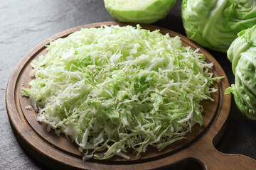 Fresh shredded cabbage on black table, closeup
