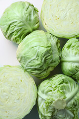 Raw green cabbages on white background, flat lay