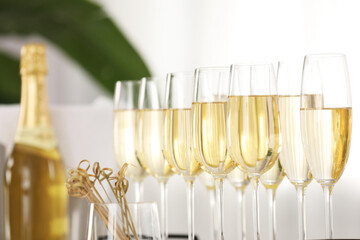 Champagne in glasses, bottle and skewers indoors, closeup
