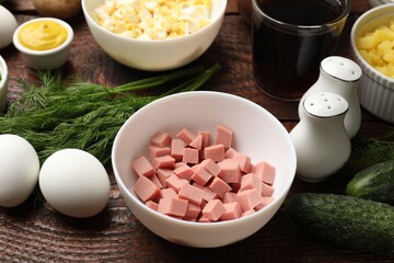 Different ingredients for okroshka soup on wooden table, closeup