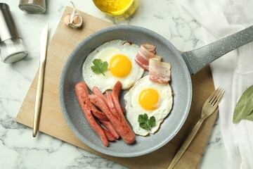 Tasty brunch. Fried eggs, sausages and bacon served on white marble table, flat lay