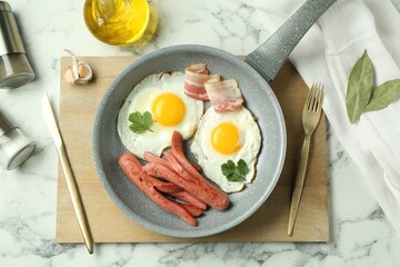 Tasty brunch. Fried eggs, sausages and bacon served on white marble table, flat lay