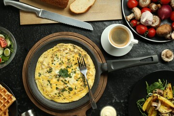 Tasty food served for brunch on black table, flat lay