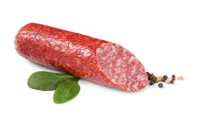 Piece of delicious smoked sausage with basil and peppercorns isolated on white