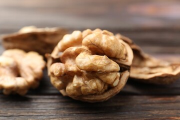 Fresh walnuts on wooden table, closeup view