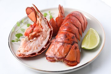 Delicious tails of boiled lobsters served on white table, closeup