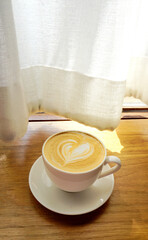 Latte coffee on wooden table, Close up shot