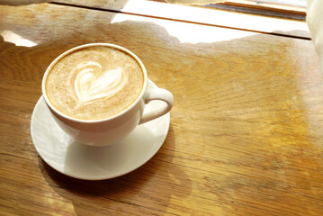 Latte coffee on wooden table, Close up shot