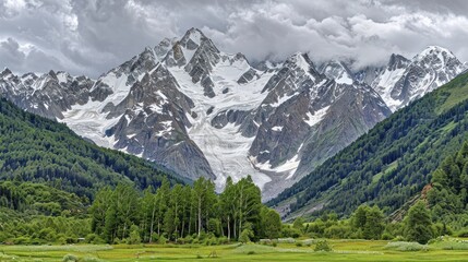 Obraz premium Majestic Snow-Capped Mountains and Lush Green Valley