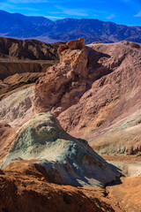 A mountain range with a large rock formation in the middle