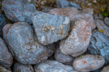Rocks of various sizes and colors form a natural landscape near a trail