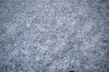 Gravel surface stretches across a pathway in an outdoor setting