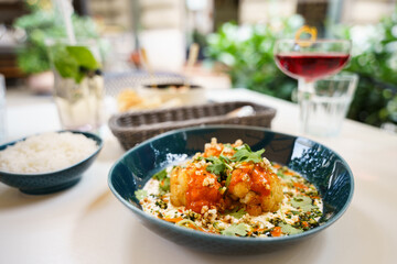 Roasted cauliflower with spicy sauce and herbs